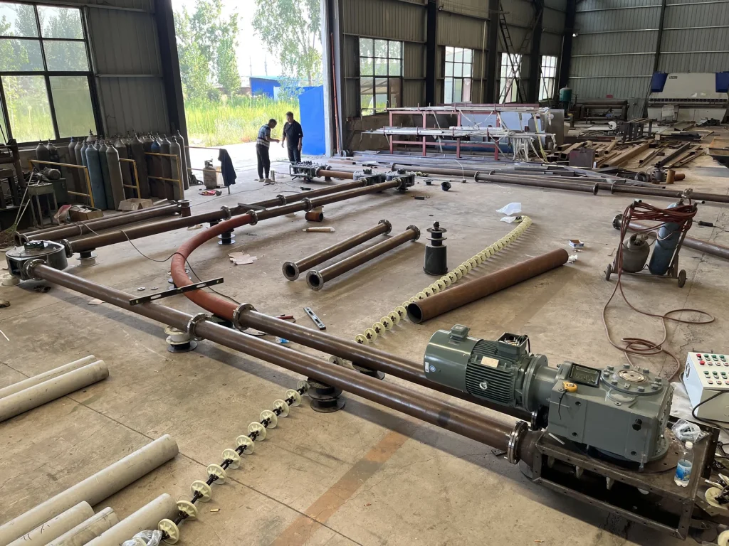 Horizontal pipe chain conveyor showing the drive and conveying discs